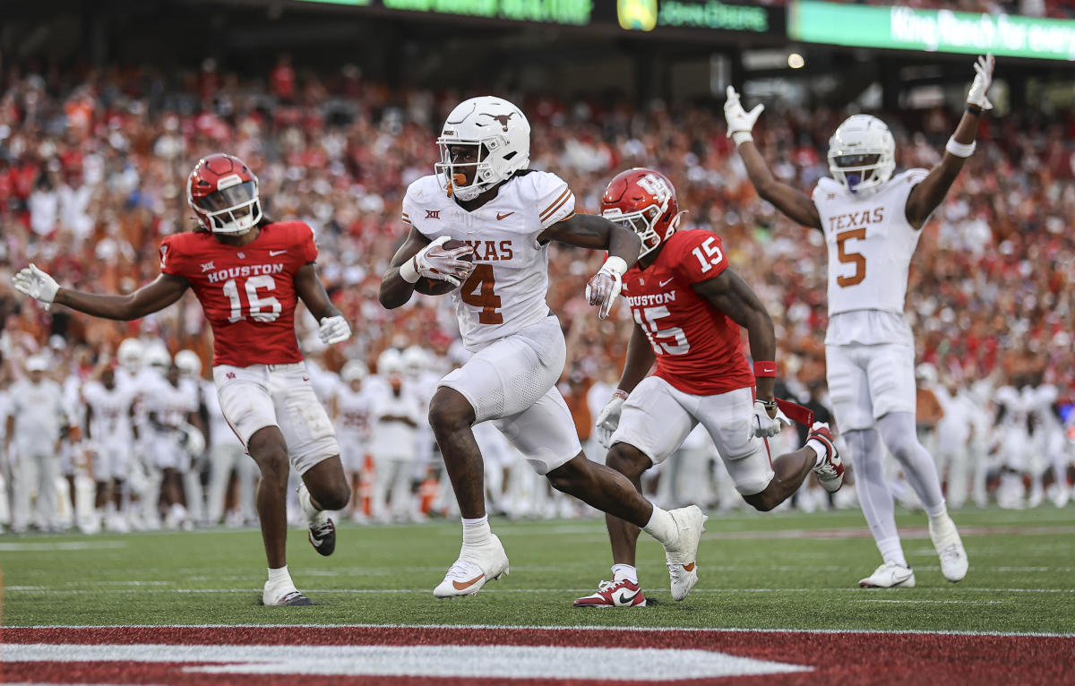 Texas running back C.J. Baxter (No. 4) crosses the goal line for a touchdown in the fourth quarter against Houston at TDECU Stadium in Houston, Texas. 